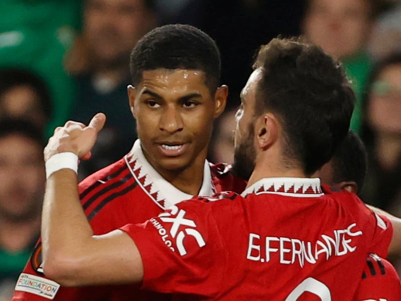Manchester United's Marcus Rashford (L) celebrates with Bruno Fernandes after scoring against Real Betis in Seville on March 16, 2023. EPA