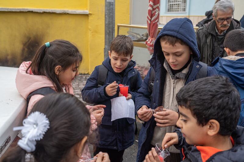 Youssef and Jamal Al Dalou enjoy snacks with classmates at their new school in Istanbul