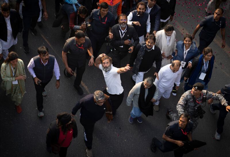 Rahul Gandhi throws flower petals towards press photographers during a march in New Delhi on December 24 last year. AP