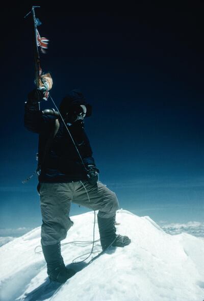 Tenzing Norgay on the Summit of Mount Everest, Tenzing Norgay on the summit of Mount Everest at 11:30am on 29th May 1953. Tenzing waves his ice-axe on which are hung the flags of Britain, Nepal, the United Nations and India, Nepal, 29th May 1953. Mount Everest Expedition 1953.  (Photo by Edmund Hillary/Royal Geographical Society via Getty Images)