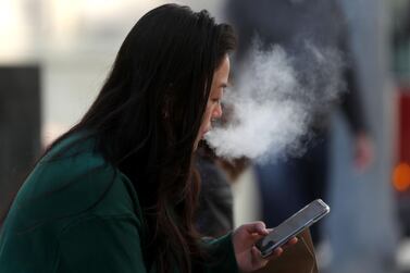 SAN FRANCISCO, CALIFORNIA - NOVEMBER 08: A pedestrian smokes an e-cigarette on November 08, 2019 in San Francisco, California. The Center for Disease Control (C.D.C.) has reported that an additive sometimes used in vaping products known as vitamin E acetate may be the cause of a national outbreak of e-cigarette-related lung injuries that has been linked to dozens of deaths. Justin Sullivan/Getty Images/AFP == FOR NEWSPAPERS, INTERNET, TELCOS & TELEVISION USE ONLY ==