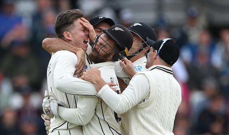 New Zealand bowler Michael Bracewell, left, is congratulated by teammates after taking the wicket of Zak Crawley for 25. Getty 