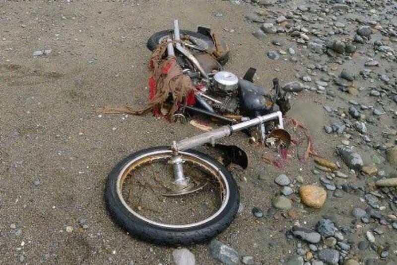 A Harley-Davidson motorbike lies on a beach in Graham Island, western Canada. Japanese media say the motorcycle lost in last year's tsunami washed up on the island about 6,400 kilometres away. The rusted bike was originally found by Peter Mark in a large white container where its owner, Ikuo Yokoyama, had kept it. The container was later washed away, leaving the motorbike half-buried in the sand. Mr Yokoyama, who lost three members of his family in the March 11, 2011, tsunami, was located through the license plate number, according to Fuji TV in Japan.