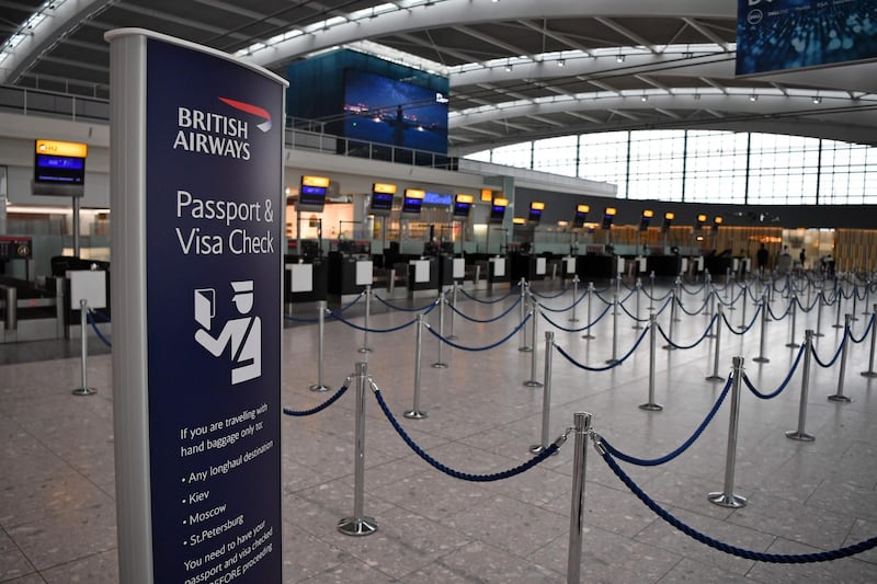 (FILES) In this file photo taken on September 09, 2019 unused check-in desks are pictured in a near-deserted departure area at Heathrow airport Terminal 5 in west London. London-listed airline giant IAG admitted on October 31, 2019 that recent historic strikes by British Airways pilots had hurt its performance in the third quarter. / AFP / Ben STANSALL
