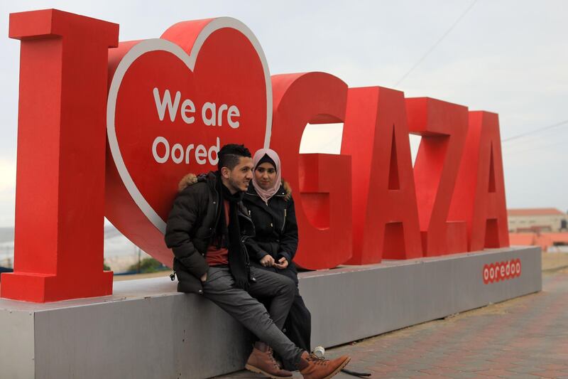 A Palestinian groom sits with his fiancee by a beach in Gaza City. AFP