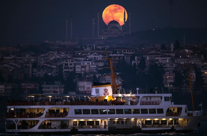 The moon rises above the Camlica Mosque in Istanbul, Turkey. Sedat Suna / EPA.