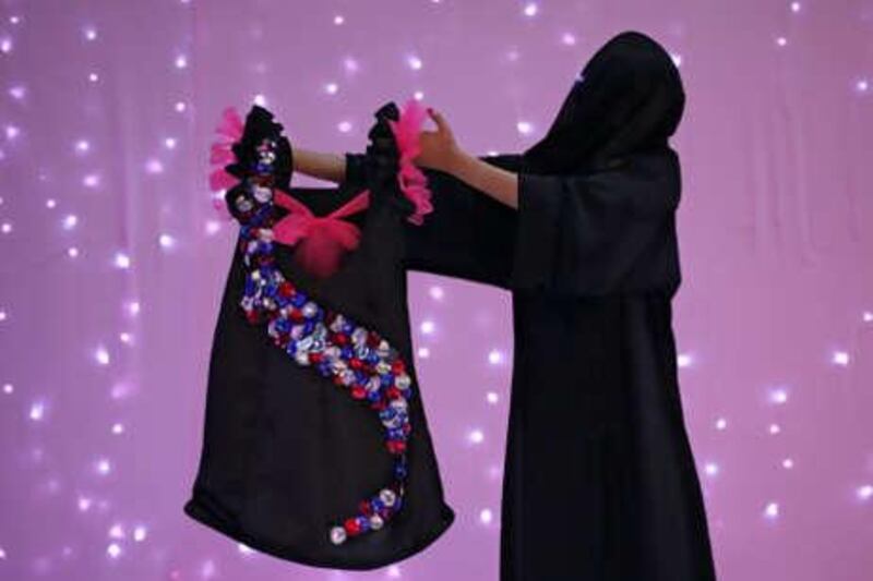 Sondos al Muhairi, 16, shows off the dress she designed for a charity fashion show at Sheikh Zayed Private Academy.