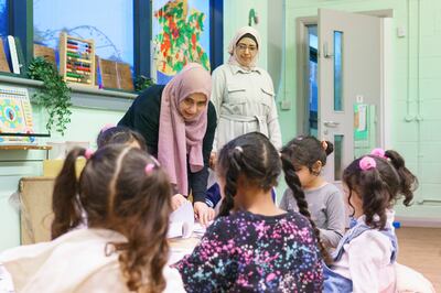 Faiza Shaibi, far left, and a teacher during lesson at the Arabic school run by the Yemeni community in Sheffield. Dominic Lipinski for The National