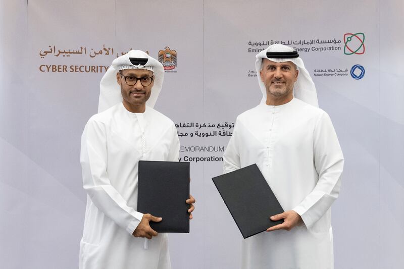 Mohamed Al Kuwaiti (left), head of cybersecurity for the UAE government, and Mohamed Al Hammadi (right), managing director and chief executive of Enec. The two entities will exchange information and expertise on cyber security-related matters. Enec