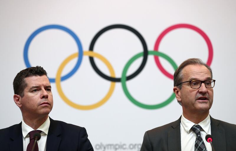 International Olympic Committee (IOC) sports director Kit McConnell (L) and spokesperson Mark Adams (R) attend a press conference in Tokyo on November 30, 2018. The International Olympic Committee froze preparations for boxing at the 2020 Games on November 30 and launched a probe into the sport's troubled governing body, warning that it could be stripped of the ability to organise the competition. / AFP / Behrouz MEHRI
