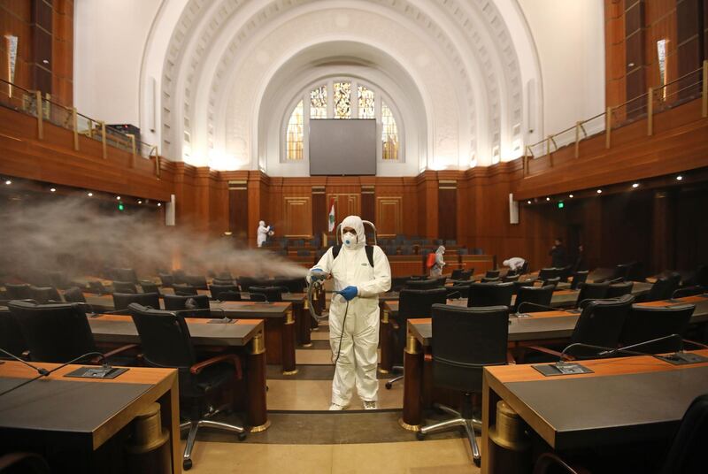 Sanitary workers disinfect the desks and chairs of the Lebanese Parliament in central Beirut. AFP