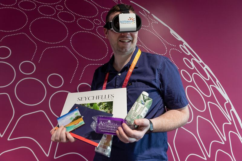 National reporter Patrick Ryan with some of the freebies he was able to collect at Expo 2020. Photo: Antonie Robertson / The National