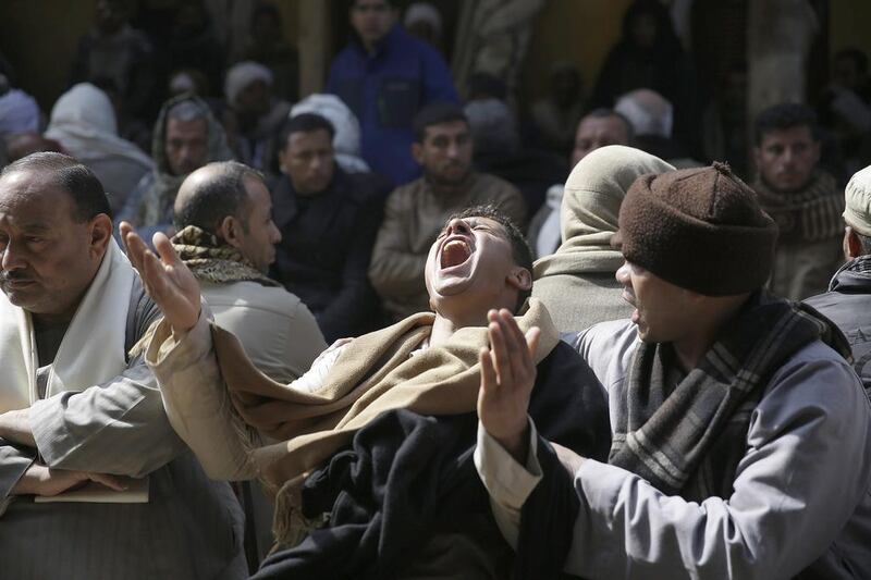 Relatives and friends mourn the deaths of 21 Egyptian Coptic Christians seized and beheaded by ISIL militants in the central city of Sirte, Libya at the Virgin Mary Church in the village of Al Our, near Minya, where more than half of the victims came from. Hassan Ammar/AP Photo