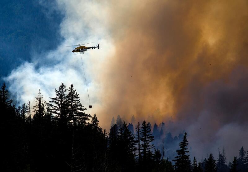 A helicopter transports water to contain the Weston Pass Fire near Fairplay, Colorado. AP Photo