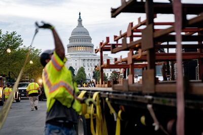 A worker secures security fencing on a truck before a planned 'Justice for J6' rally outside the US Capitol in Washington. Bloomberg