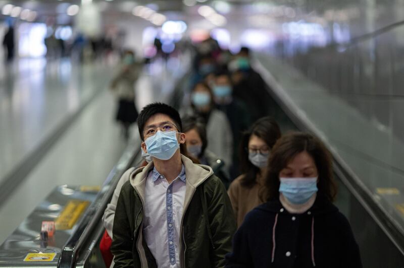 Commuters wear face masks in the MTR in Hong Kong.  EPA