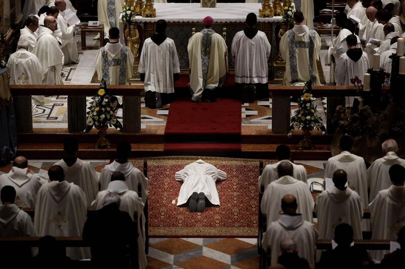 A Franciscan friar lies on the floor as he prays the Litany of the Saints during the ceremony of his ordination to be a deacon, at the Saint Saviour Convent in the Old City of Jerusalem. AFP