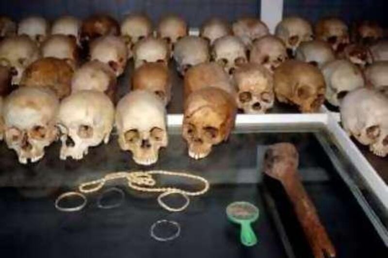 Skulls belonging to the victims of the 1994 Rwandan genocide are shown in a display case at the Nyamata church, Nov. 24, 2006, outside of Kigali, Rwanda.  Also shown are some possessions of the victims along with a club used to kill victims. (AP Photo/Jody Kurash)