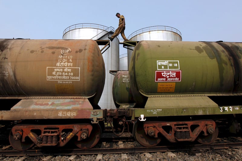 A worker walks atop oil tanker wagons at an oil terminal near Kolkata, India. The stalemate within the world's main oil-exporting bloc has left traders uncertain about future supply. Reuters