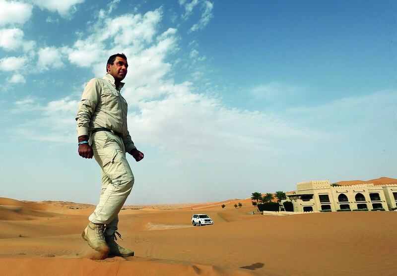 Ajab Khan, who is taking part in Jawbone challenge, walks in the dunes outside the Qasr Al Sarab Hotel in Liwa, Abu Dhabi. Satish Kumar / The National 