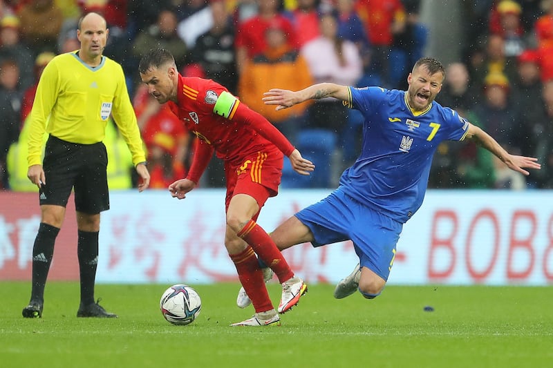 Wales midfielder Aaron Ramsey fights for the ball with Ukraine's Andriy Yarmolenko. AFP