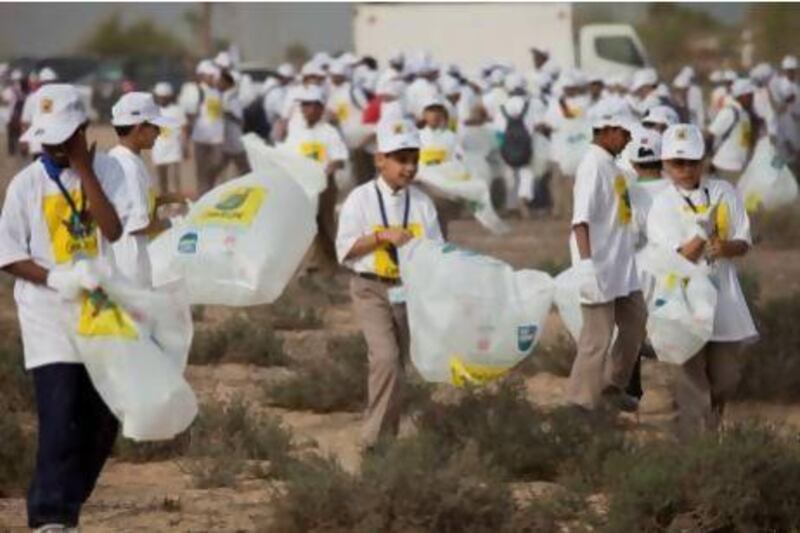 Schoolchildren volunteers pick up trash at a desert area near Nad Al Sheba. An estimated 5,000 volunteers took part in the 11th 'Clean up UAE' drive at the desert area.