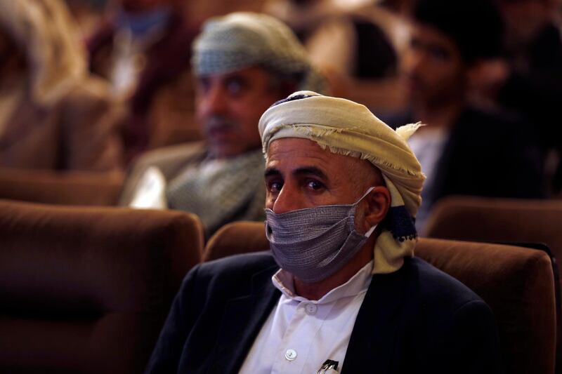 A Yemeni wears a protective face mask while attending a meeting on coronavirus awareness amid the ongoing coronavirus Covid-19 pandemic in Sanaa. EPA