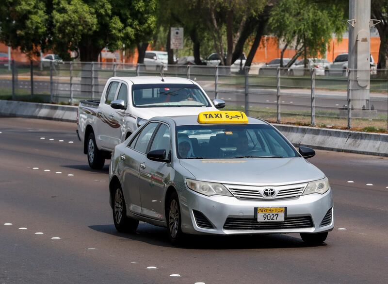 Abu Dhabi, U.A.E., July 11, 2018.  Stock photos of transportation - public buses, bus waiting sheds, taxis, passengers, bus ticket machines, mawaqif.   ---  An Abu Dhabi taxi goes Northbound along Sheikh Rasheed Bin Saeed Street.
Victor Besa / The National
Section: NA
Reporter: