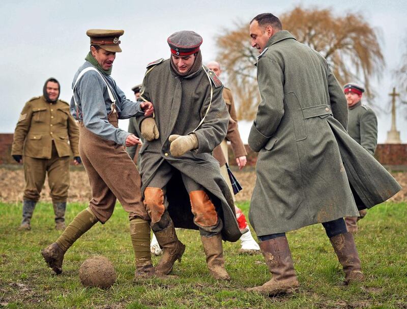 Men dressed up as German (C) and British (L) soldiers re-enact the no-man's land football match between British and German soldiers in 1914 (EPA/STEPHANIE LECOCQ)