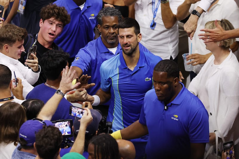 Novak Djokovic high fives fans after defeating Daniil Medvedev in the US Open final. AFP