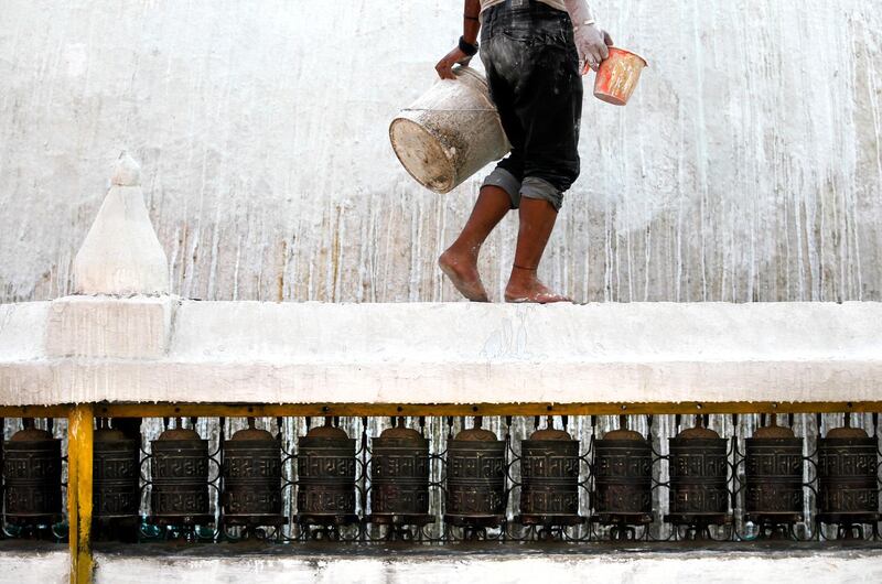 A Nepalese worker paints Dhando Chaitya stupa in Kathmandu, Nepal. Niranjan Shrestha / AP Photo