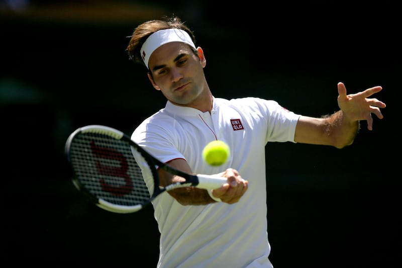 Roger Federer of Switzerland returns the ball to Serbia's Dusan Lajovic during their Men's Singles first round match at the Wimbledon Tennis Championships in London, Monday July 2, 2018. (AP Photo/Tim Ireland)