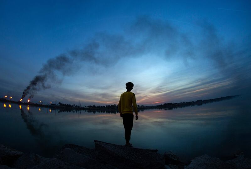 A young Iraqi next to Basra's oil fields. AFP