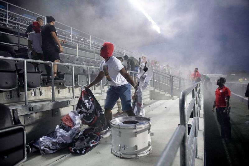 Toronto FC fans are chucked out of the stadium after a flare was thrown onto the field during the second half of the first leg in the semi-finals between Toronto FC and Ottawa Fury FC in the Canadian football championships in Ottawa, Ontario. Justin Tang/AP Photo