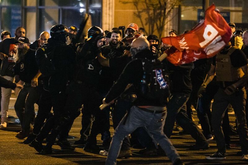 Members of Antifa and Proud Boys clash in the middle of the street following the "Million MAGA March"  in Washington, DC. AFP
=