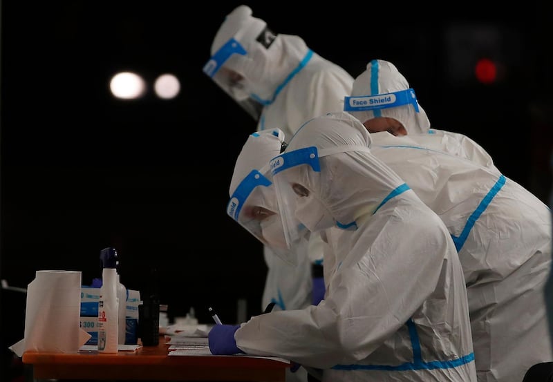 Medical staffers work at a triage checkpoint that was set to ease the pressure on hospital emergency wards, following a surge of Covid-19 case numbers, in Milan, Italy. AP