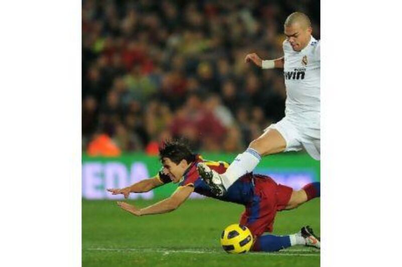 Bojan Krkic, left, of Barcelona fights for the ball with Pepe of Real Madrid in a 5-0 rout by Barcelona. A reader claims that Barcelona are invincible and Madrid must now resort to defence and counter-strikes.