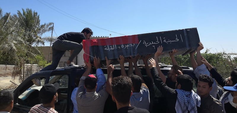 Mourners carry the coffin of an Iraqi demonstrator, who was killed during ongoing anti-government protests in Basra, Iraq May 11, 2020. REUTERS/Stringer