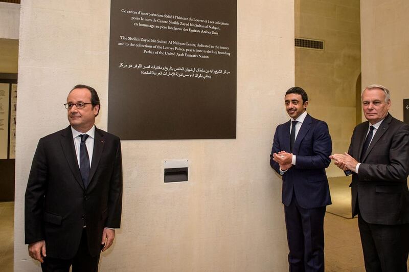 French president Francois Hollande, left, Sheikh Abdullah bin Zayed, centre, and French foreign minister Jean-Marc Ayrault unveil a commemorative plaque. Christophe Petit Tesson / AFP