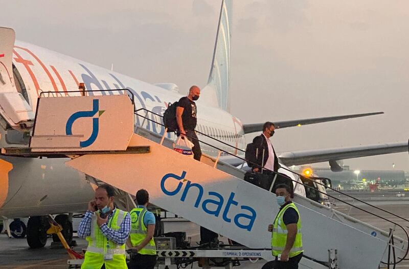 Israeli tourists leave a flydubai plane which departed from Ben-Gurion International Airport in Tel Aviv and landed in Dubai, United Arab Emirates, Sunday, Nov. 8, 2020. The first flight carrying Israeli tourists to the UAE landed Sunday in the city-state of Dubai, the latest sign of the normalization deal reached between the two nations. (AP Photo/Malak Harb)