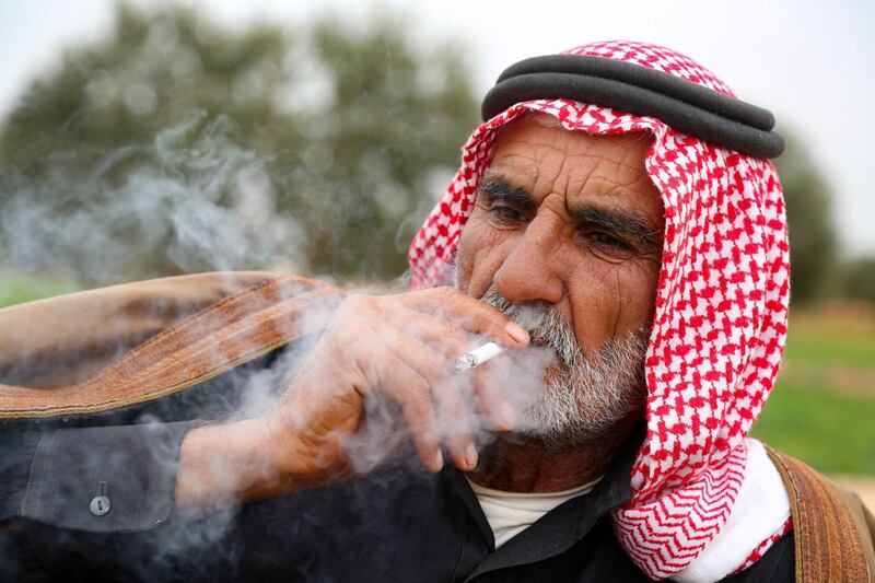 Abderrazaq Khatoun smokes a cigarette. AFP