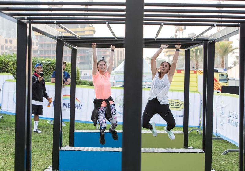 DUBAI, UNITED ARAB EMIRATES - Participants doing an obstacle course at the closing weekend carnival of the second year of the Dubai Fitness Challenge at Burj Park, Dubai.  Leslie Pableo for The National