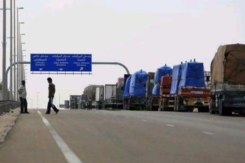 A line of trucks waits to cross the Ghweifat border into Saudi Arabia. Ryan Carter / The National