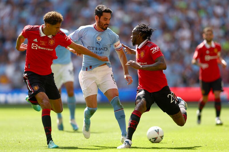 Ilkay Gundogan  is challenged by Raphael Varane and Aaron Wan-Bissaka of Manchester United at the Wembley Stadium. Getty