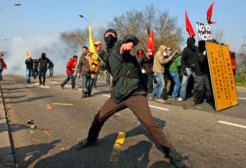 A protester throws a stone during clashes at the Nato summit in 2009 in Strasbourg, France