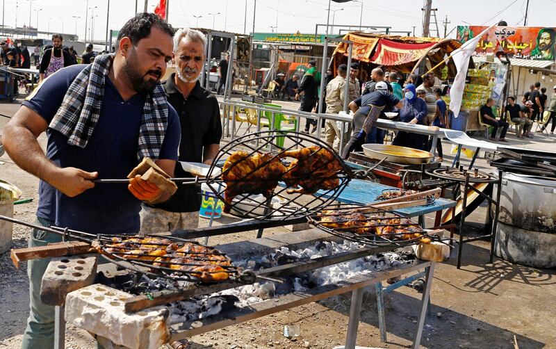 Iraqi volunteers grill chicken to be served to Shiite Muslim pilgrims as they walk to Kerbala, ahead of the Shiite ritual of Arbaeen. Reuters