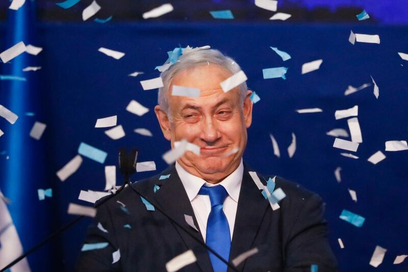Israeli Prime Minister Benjamin Netanyahu smiles after first exit poll results for the Israeli elections at his party's headquarters in Tel Aviv, Israel, Monday, March 2, 2020. (AP Photo/Ariel Schalit)