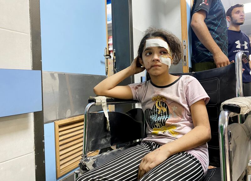 A Palestinian girl wounded in Israeli strikes waits for treatment at Al Shifa hospital, in Gaza city. Reuters