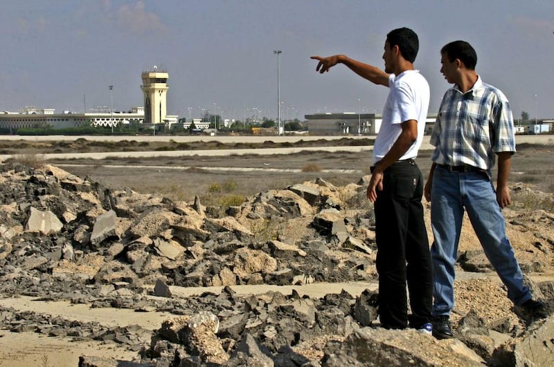 November 8, 2004: Palestinian security personnel walk on the Gaza international airport strip that was destroyed by the Israeli army bulldozers nearly three years before. Said Khatib/AFP Photo