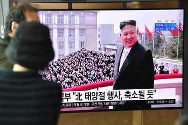 People watch a television news broadcast showing file footage of North Korean leader Kim Jong Un, at a railway station in Seoul on April 14, 2020. AFP